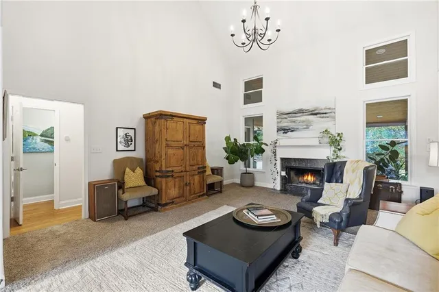 a living room with furniture stairs and a potted plant