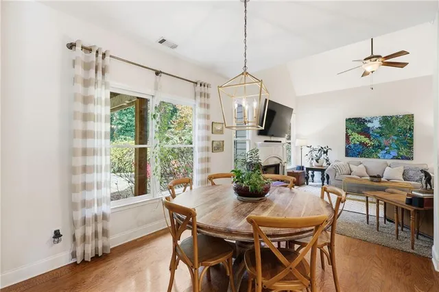 a living room with furniture kitchen view and a dining table