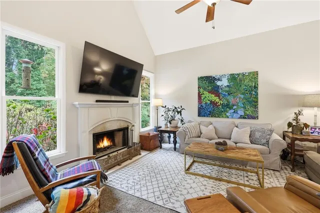 a living room with furniture a flat screen tv and a fireplace