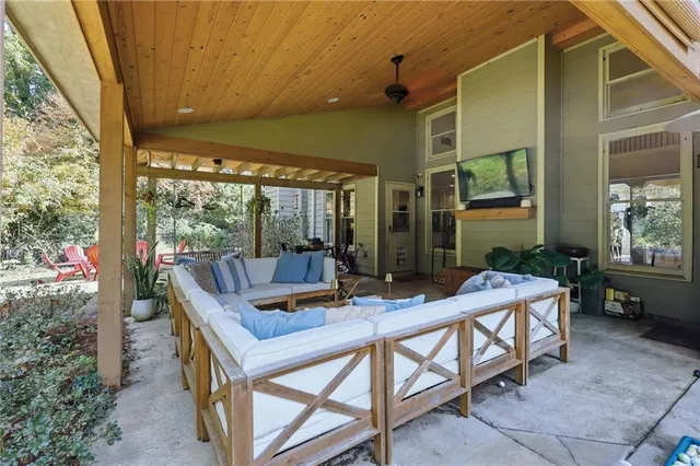 a view of a wooden chairs and table in the patio
