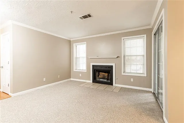 a view of empty room with a fireplace