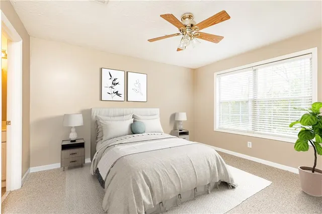 a spacious bedroom with a bed and a large window