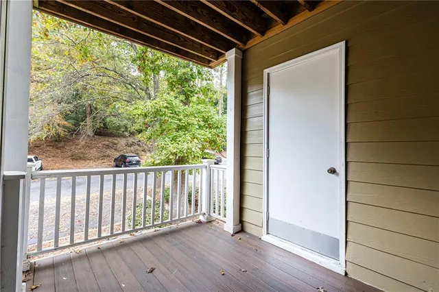 a view of a porch with wooden floor and outdoor space