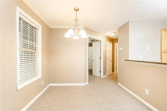 a view of a room with a windows and ceiling fan