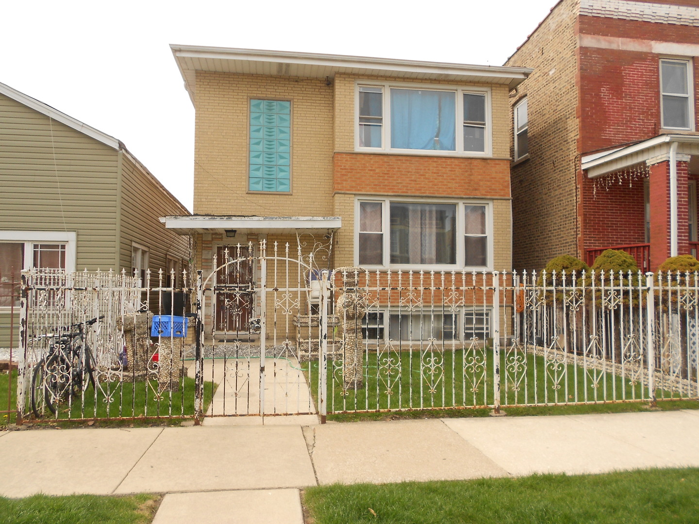 5220 South Troy Street Chicago, IL 60632 - Photo 2 of 5 a view of a brick house with a yard and plants