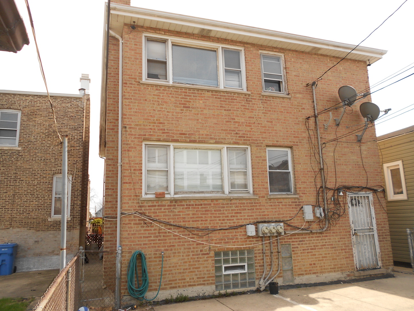 5220 South Troy Street Chicago, IL 60632 - Photo 3 of 5 a view of a brick house with large windows