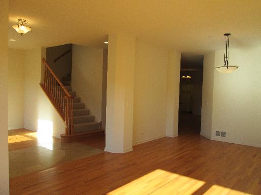 1956 Brentwood Road Northbrook, IL 60062 - Photo 3 of 16 a view of a hallway with wooden floor and staircase