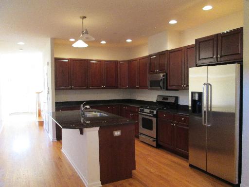 1956 Brentwood Road Northbrook, IL 60062 - Photo 6 of 16 a kitchen with wooden cabinets and stainless steel appliances