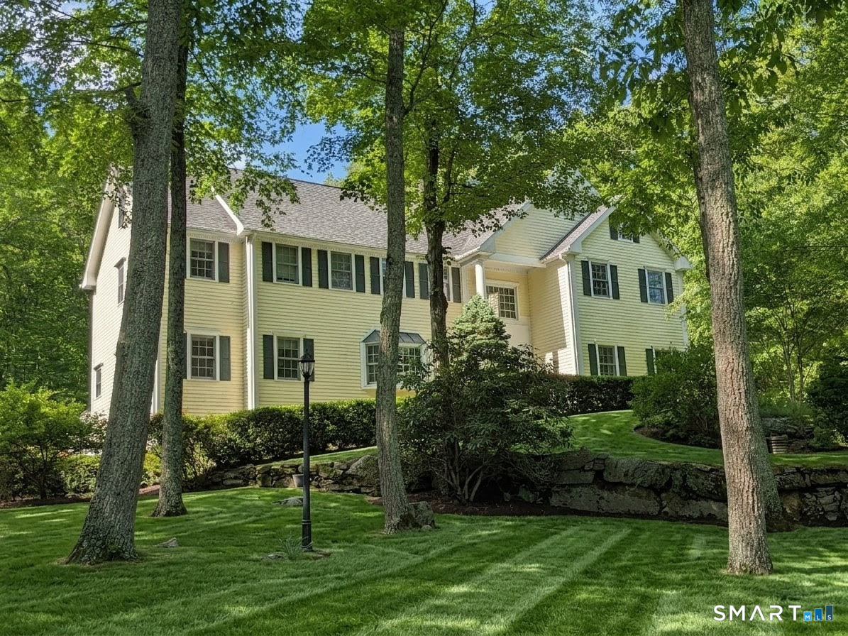 12 Carriage Hill Road Woodbridge, CT 06525 - Photo 1 of 24 a front view of a house with a garden