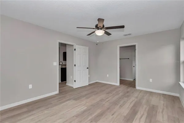 a view of empty room with wooden floor