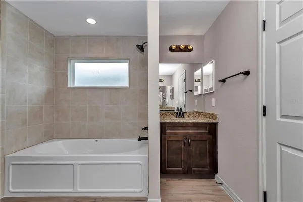 a bathroom with a bathtub and a sink