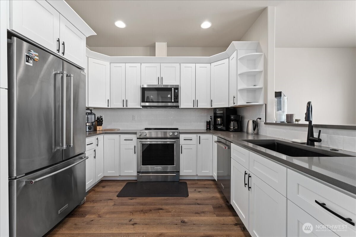 214 Solomon Loop Northwest East Wenatchee, WA 98802 - Photo 11 of 38 a kitchen with cabinets stainless steel appliances and a counter space
