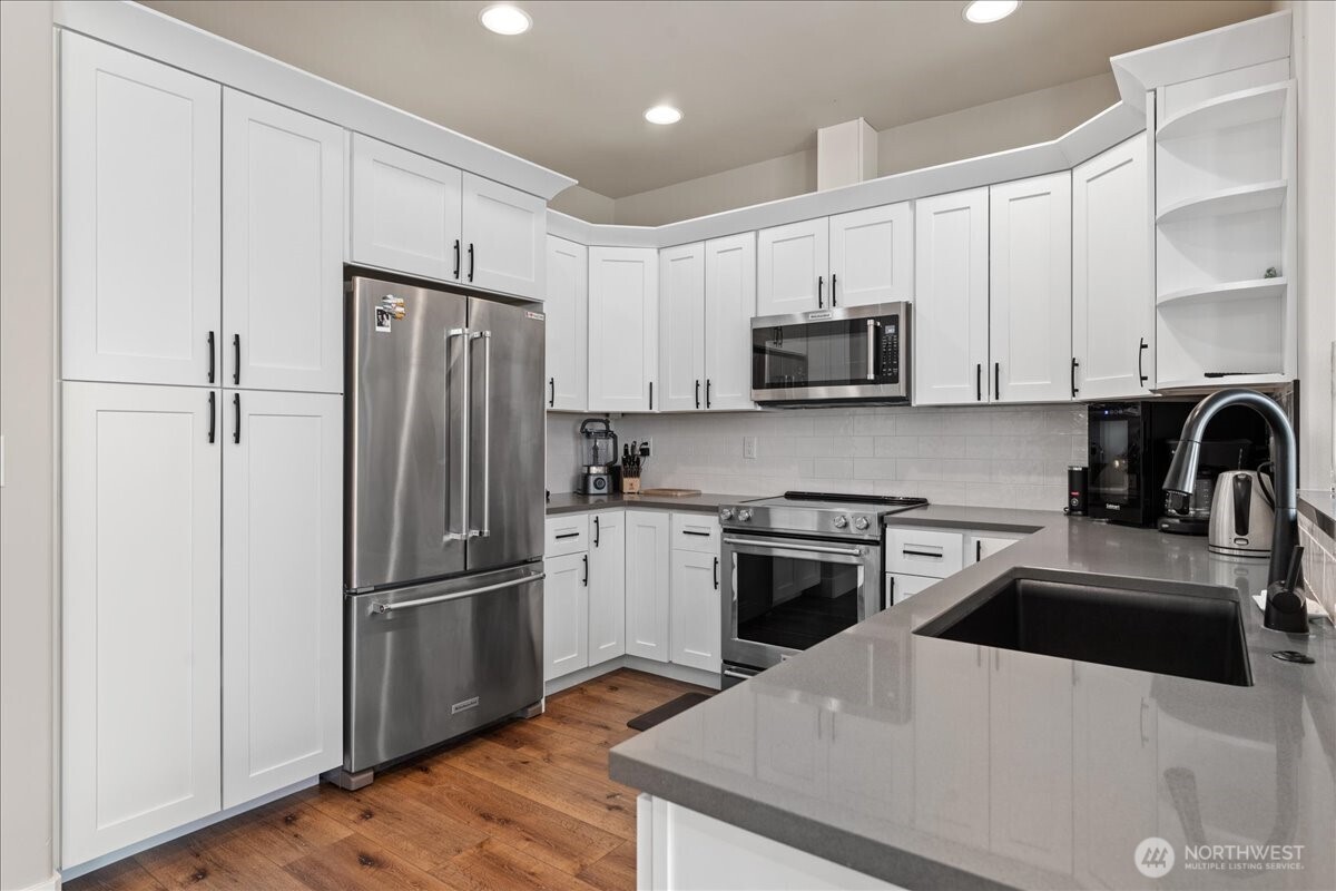 214 Solomon Loop Northwest East Wenatchee, WA 98802 - Photo 13 of 38 a kitchen with a refrigerator stove and sink