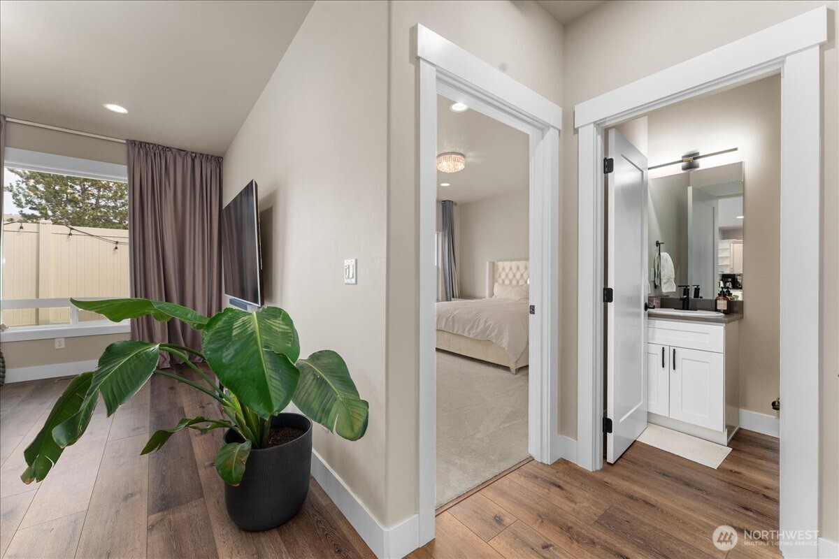 214 Solomon Loop Northwest East Wenatchee, WA 98802 - Photo 15 of 38 a view of a hallway with wooden floor and a potted plant
