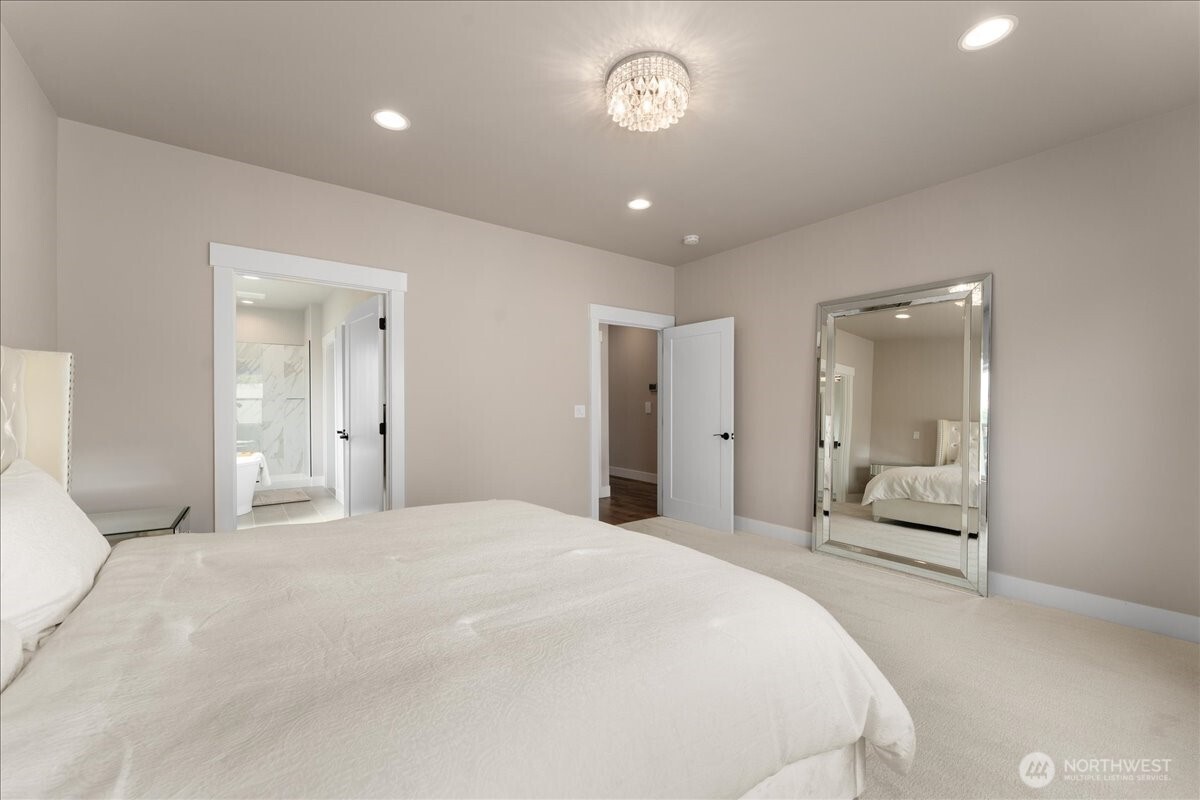 214 Solomon Loop Northwest East Wenatchee, WA 98802 - Photo 17 of 38 a bedroom with a large bed and a large mirror