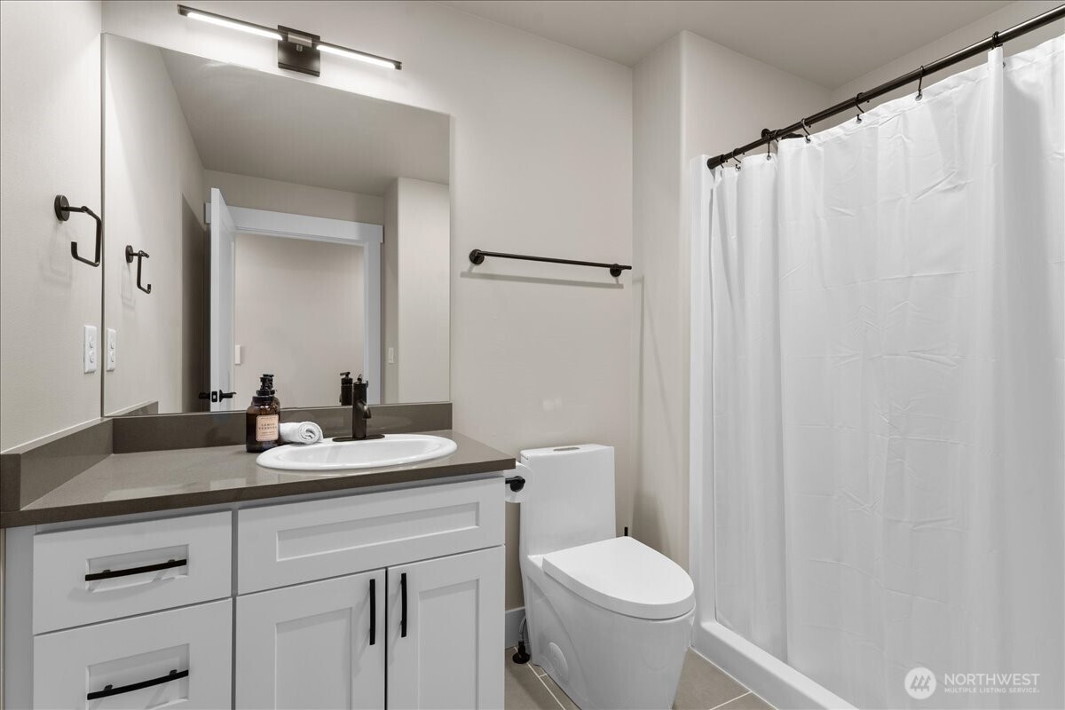 214 Solomon Loop Northwest East Wenatchee, WA 98802 - Photo 23 of 38 a bathroom with a granite countertop sink toilet and a mirror