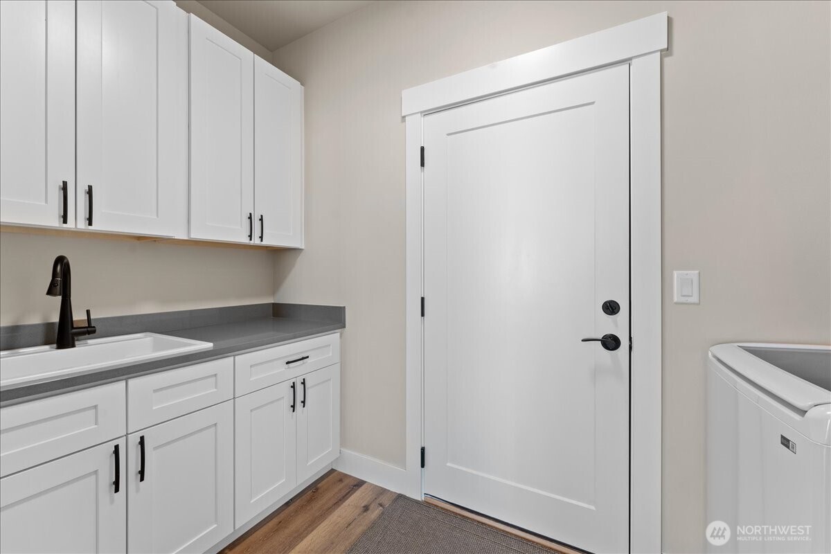 214 Solomon Loop Northwest East Wenatchee, WA 98802 - Photo 26 of 38 a kitchen with a sink and cabinets