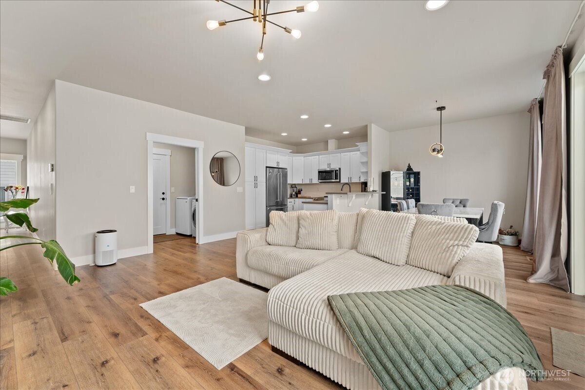 214 Solomon Loop Northwest East Wenatchee, WA 98802 - Photo 6 of 38 a living room with furniture and a wooden floor