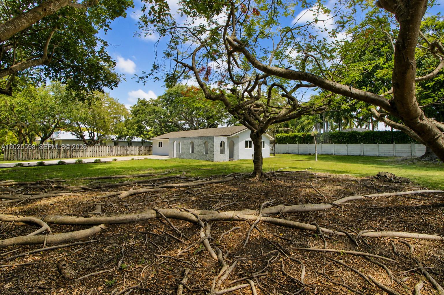 9421 Southwest 150th Street Miami, FL 33176 - Photo 3 of 31 a view of a house with a yard