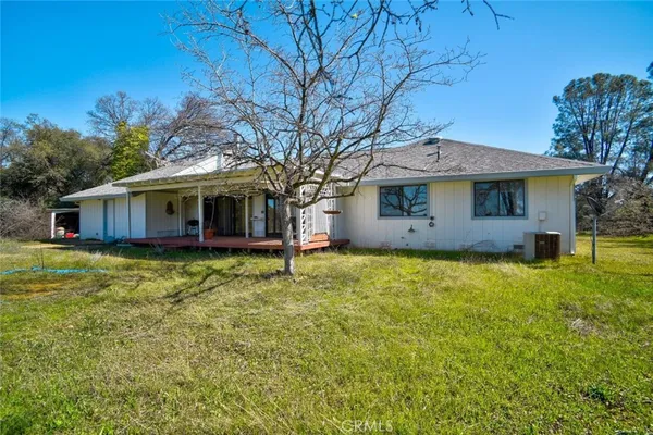 a view of a house with pool and yard