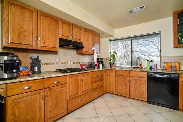 a kitchen with stainless steel appliances granite countertop a refrigerator and sink