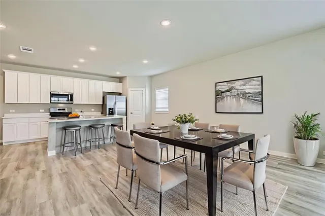 a view of a dining room with furniture and wooden floor