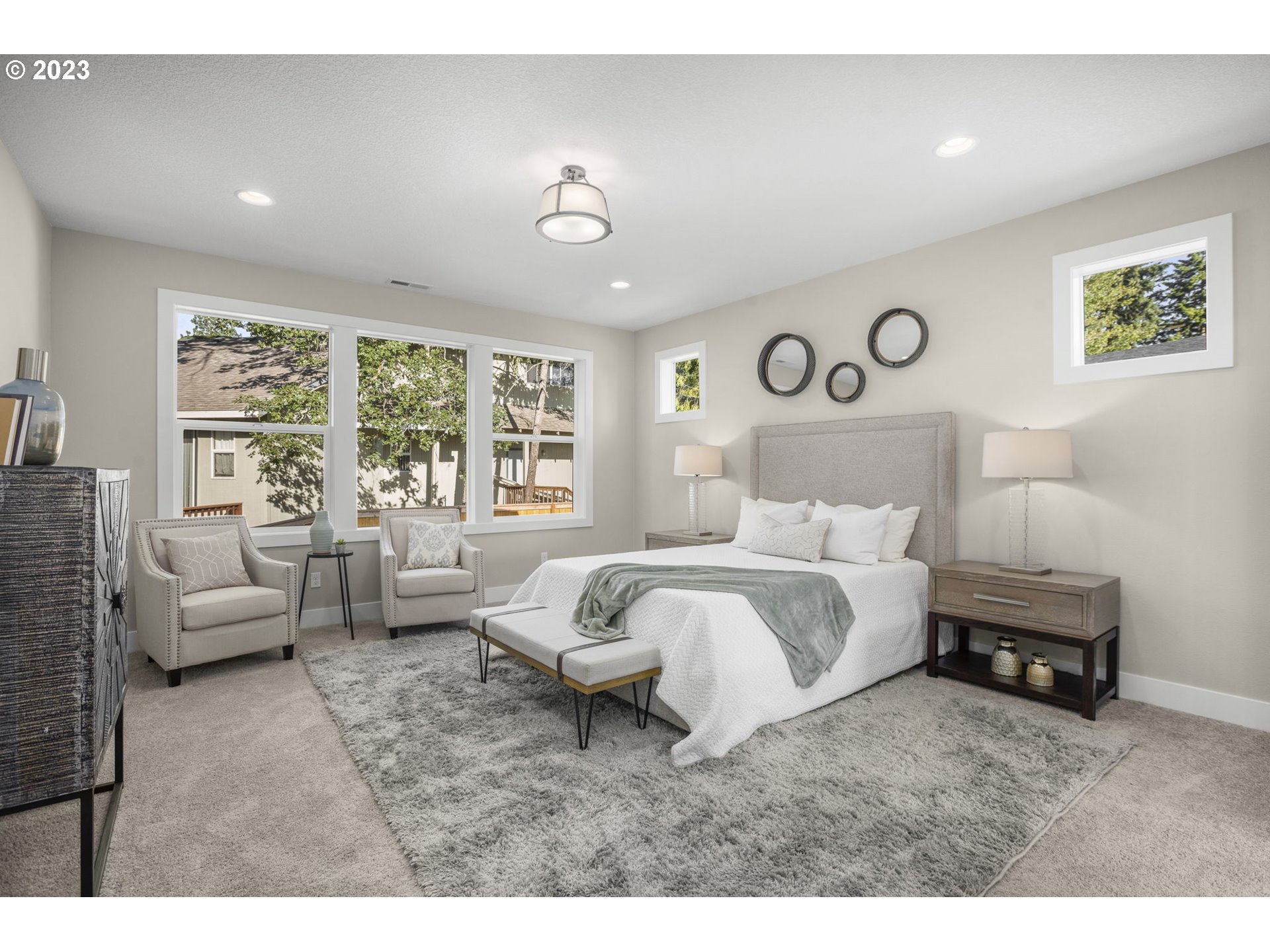 8878 Southwest Lintner Terrace Portland, OR 97223 - Photo 17 of 42 a spacious bedroom with a bed and a couch
