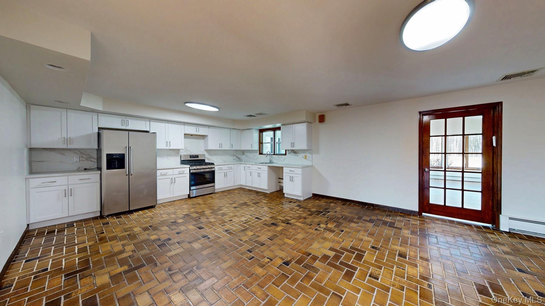 565 Prosperous Valley Road Middletown, NY 10940 - Photo 12 of 47 a kitchen with stainless steel appliances granite countertop a refrigerator sink and cabinets