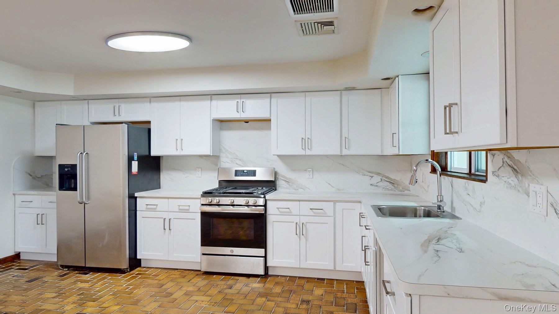 565 Prosperous Valley Road Middletown, NY 10940 - Photo 15 of 47 a kitchen with stainless steel appliances a stove a sink and a refrigerator