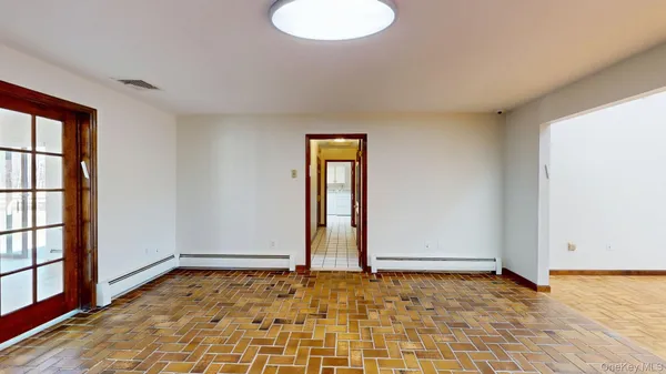 an empty room with windows and ceiling fan