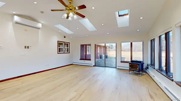 a living room with furniture and floor to ceiling window