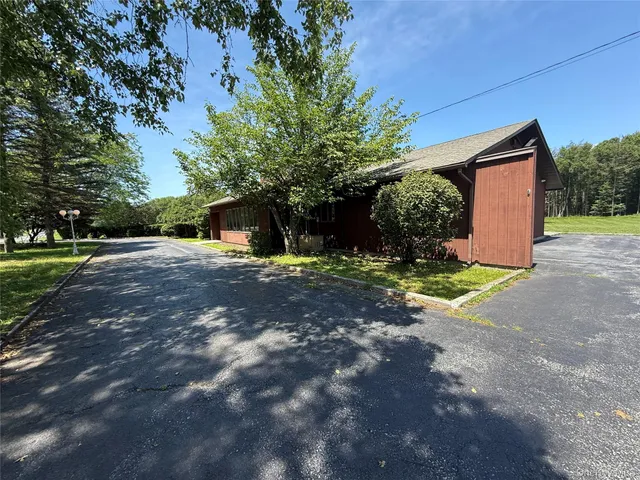 a view of a house with a yard and garage