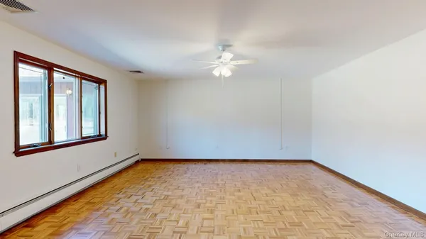 a view of empty room with a ceiling fan