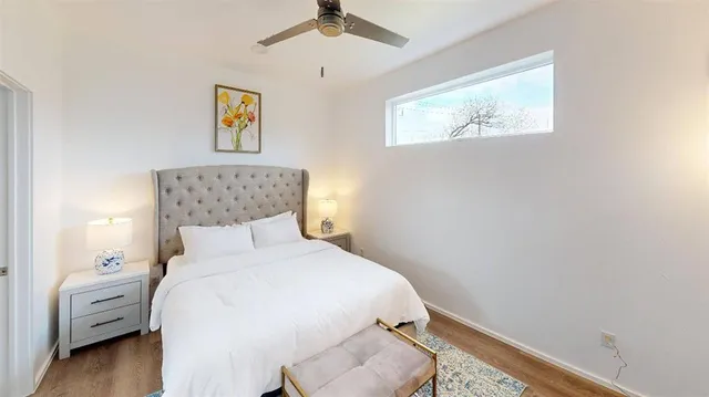 a bedroom with a bed and painting on the wall