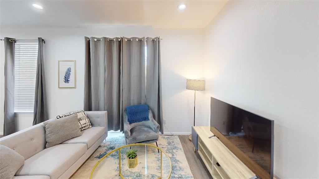 3235 Dallas Street, Unit 1201 Dallas, TX 75210 - Photo 17 of 26 a living room with furniture and a flat screen tv