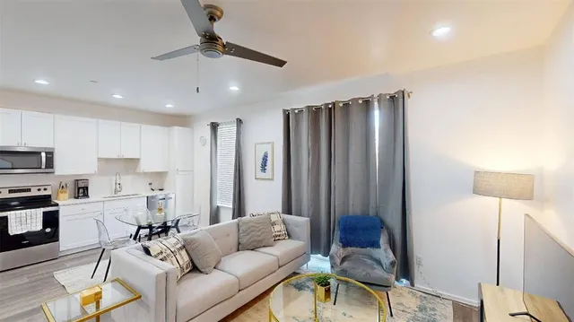 a living room with furniture and a chandelier