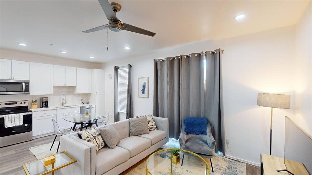 3235 Dallas Street, Unit 1201 Dallas, TX 75210 - Photo 20 of 26 a living room with furniture and a chandelier