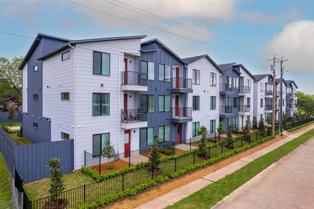 3235 Dallas Street, Unit 1201 Dallas, TX 75210 - Photo 22 of 26 a front view of a residential apartment building with a yard and potted plants