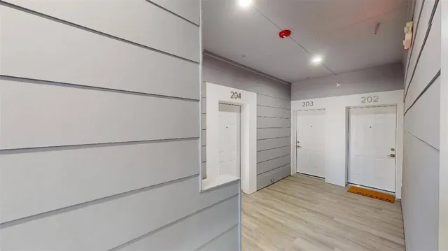 a hallway view with wooden floor