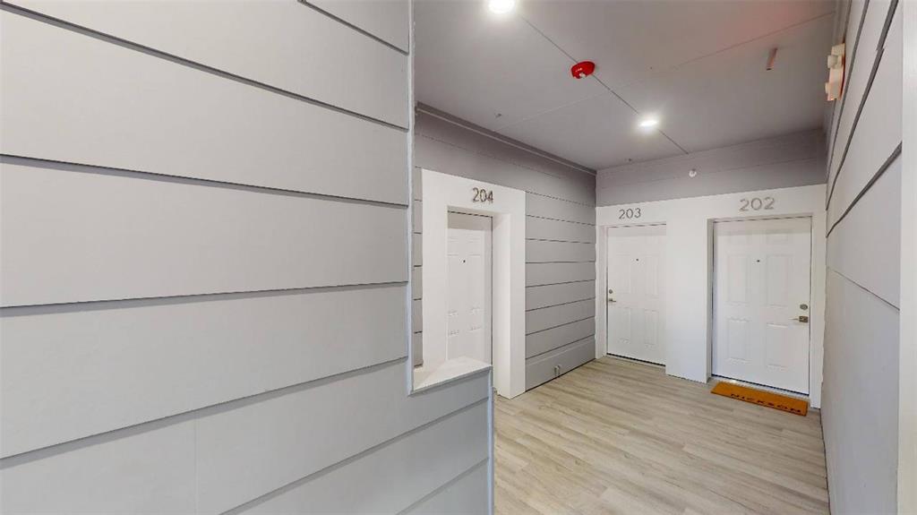 3235 Dallas Street, Unit 1201 Dallas, TX 75210 - Photo 24 of 26 a hallway view with wooden floor