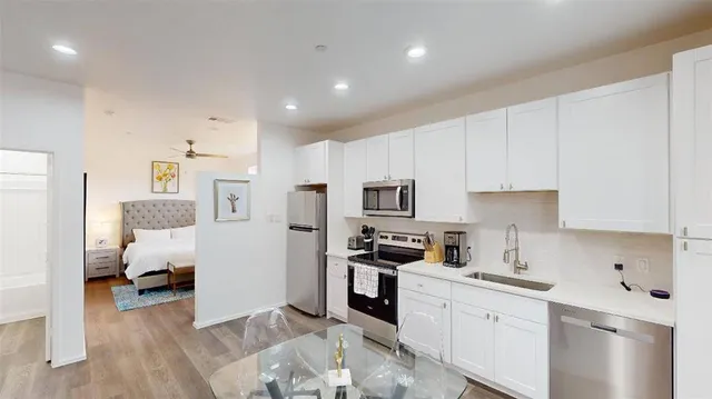 a kitchen with stainless steel appliances granite countertop a refrigerator sink and cabinets