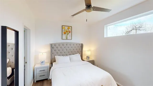 a bedroom with a bed and a painting on the wall