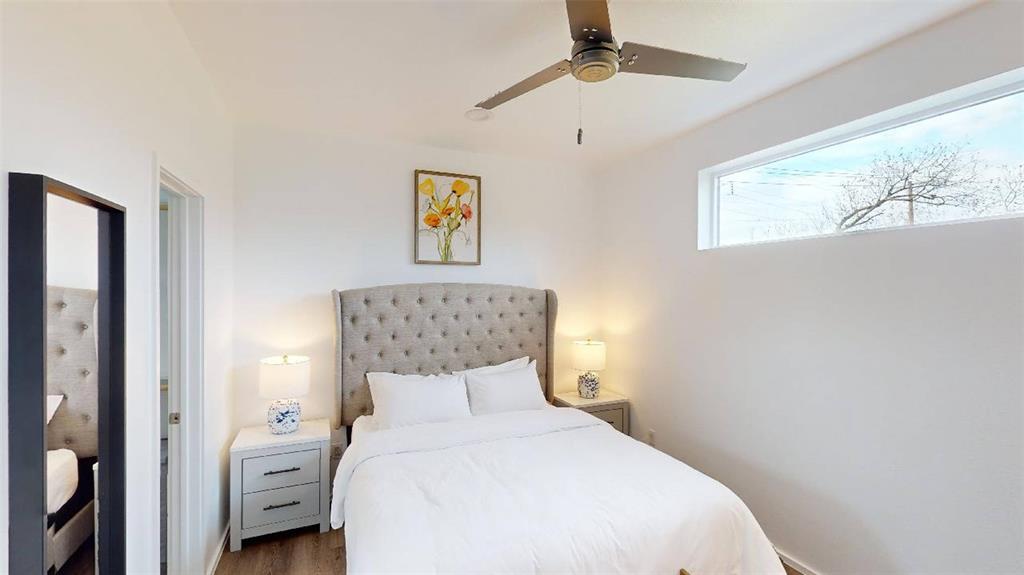 3235 Dallas Street, Unit 1201 Dallas, TX 75210 - Photo 7 of 26 a bedroom with a bed and a painting on the wall