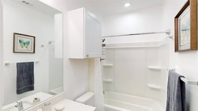 a bathroom with a shower and a toilet