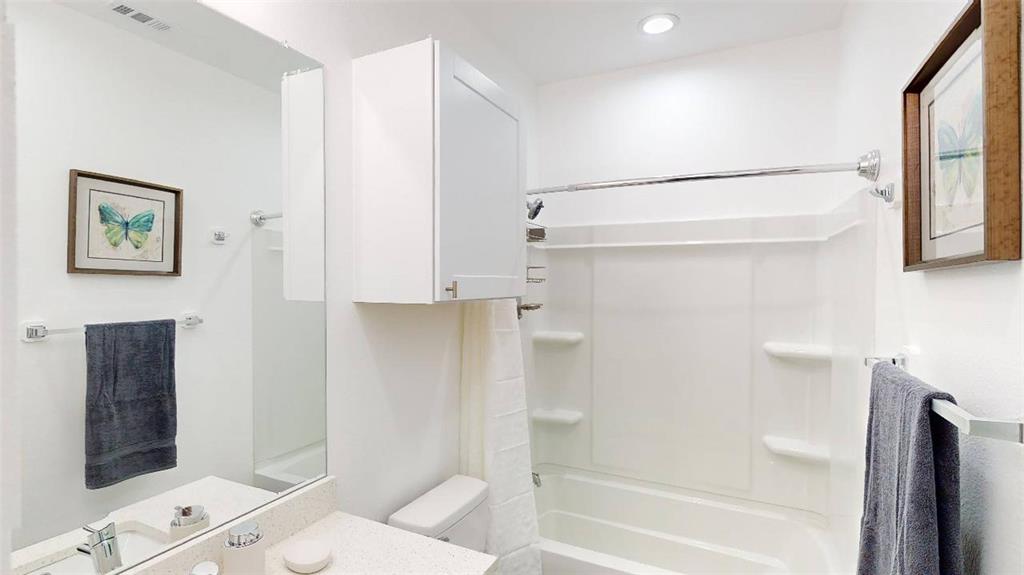 3235 Dallas Street, Unit 1201 Dallas, TX 75210 - Photo 10 of 26 a bathroom with a shower and a toilet
