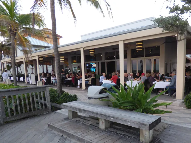 a view of people sitting in front of retail shops