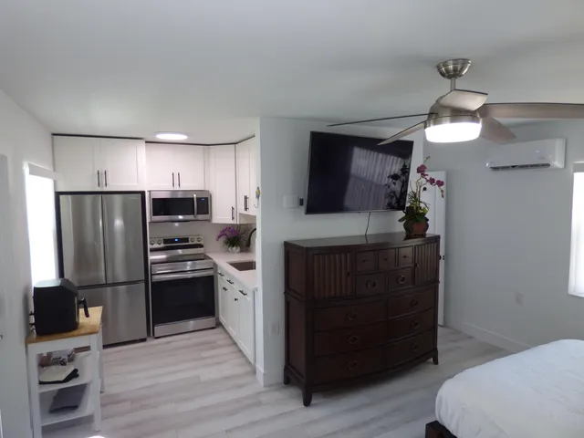 a kitchen with a refrigerator and a sink