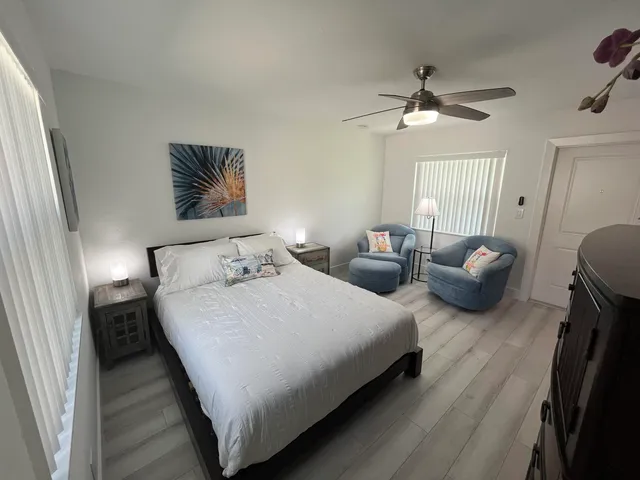 a bedroom with bed and a chandelier