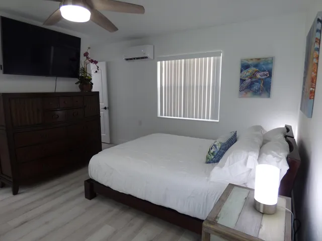 a bed sitting in a bedroom next to a window