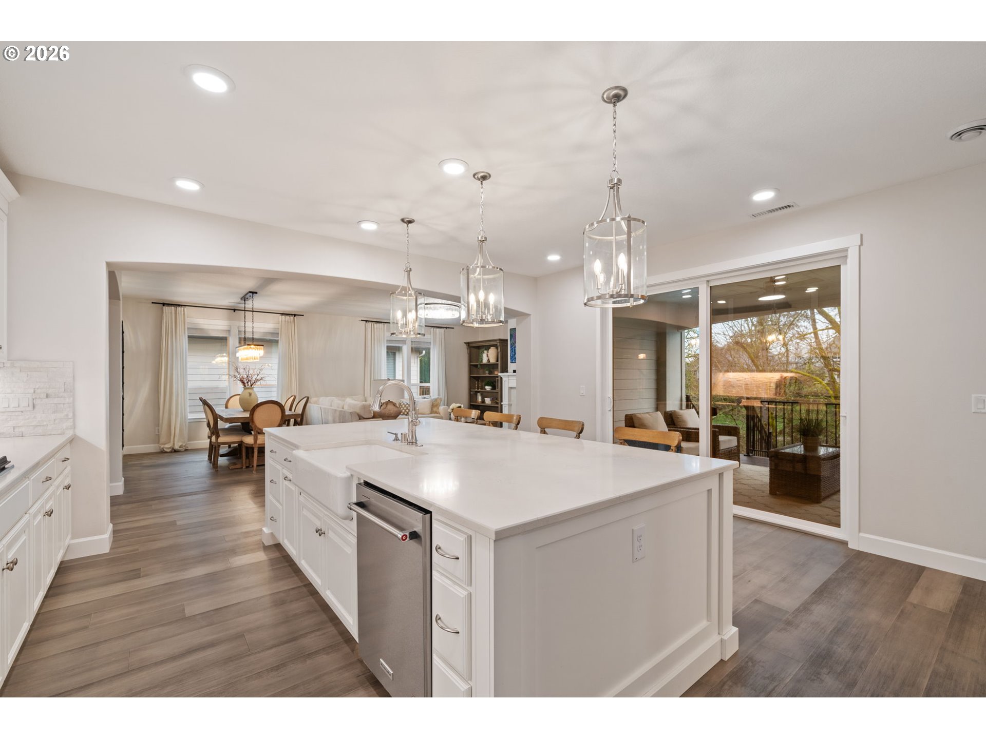 4024 South Winery Way Ridgefield, WA 98642 - Photo 18 of 48 a large kitchen with kitchen island a stove a sink a refrigerator and a view of living room
